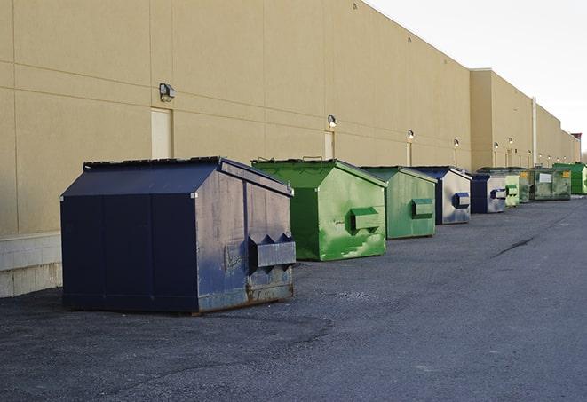 a fleet of red and blue construction dumpsters available for use in Bellvue